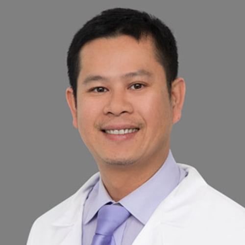A portrait of Dr. Hung Chung, a smiling man in a white lab coat with a stethoscope.